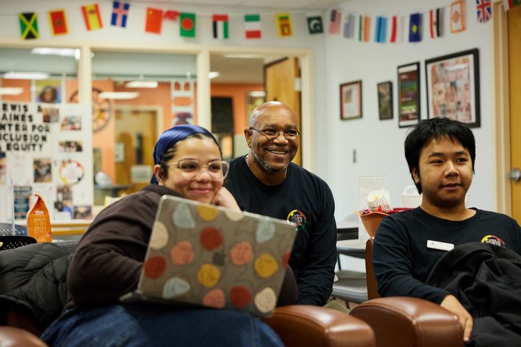 Two students and a staff member converse in the LGCIE lounge area.
