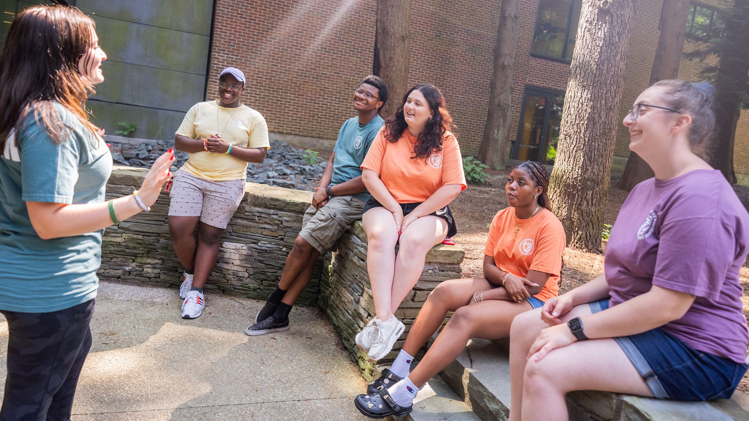 A group of students talks together on a patio.